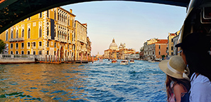 View of tourists from a boat travelling along the Grand Canal in Venice